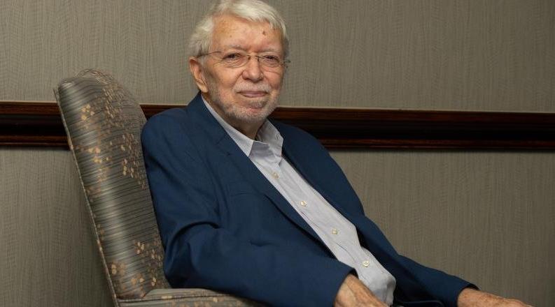 Wayne Talley, Ph.D., seated in a chair